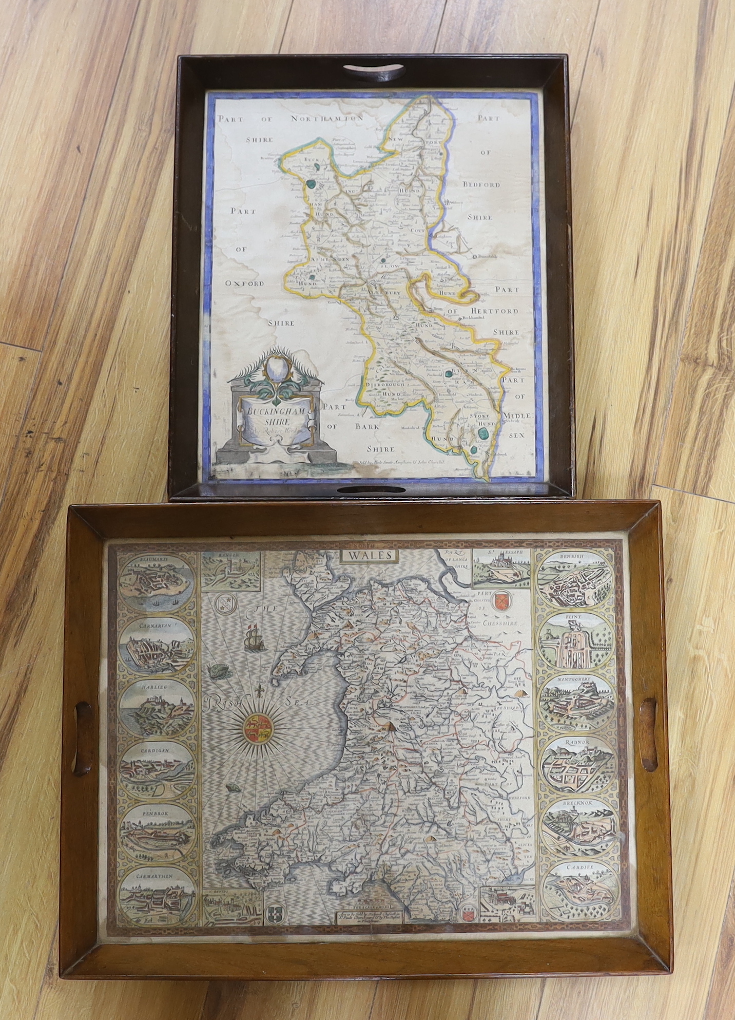 An 18th century hand coloured map of Wales, framed as a twin handled drink’s tray, together with another after Robert Morden, Buckinghamshire, largest 58cm wide (2)